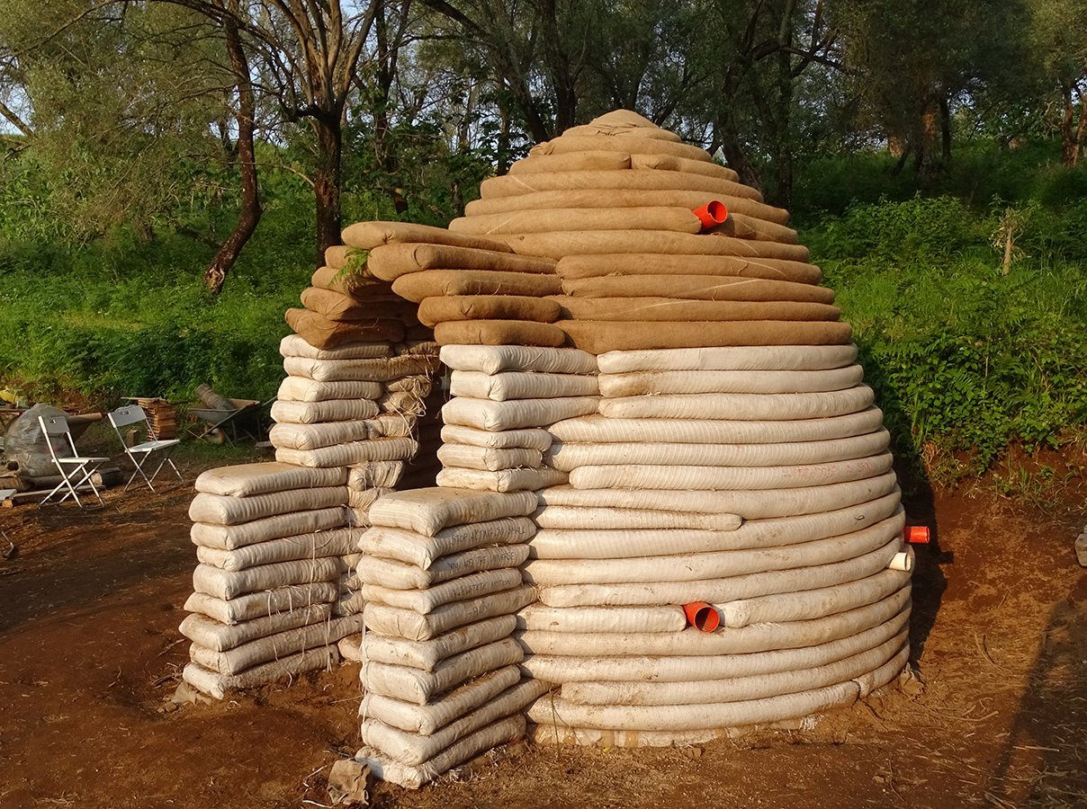 superadobe earth dome in the forest
