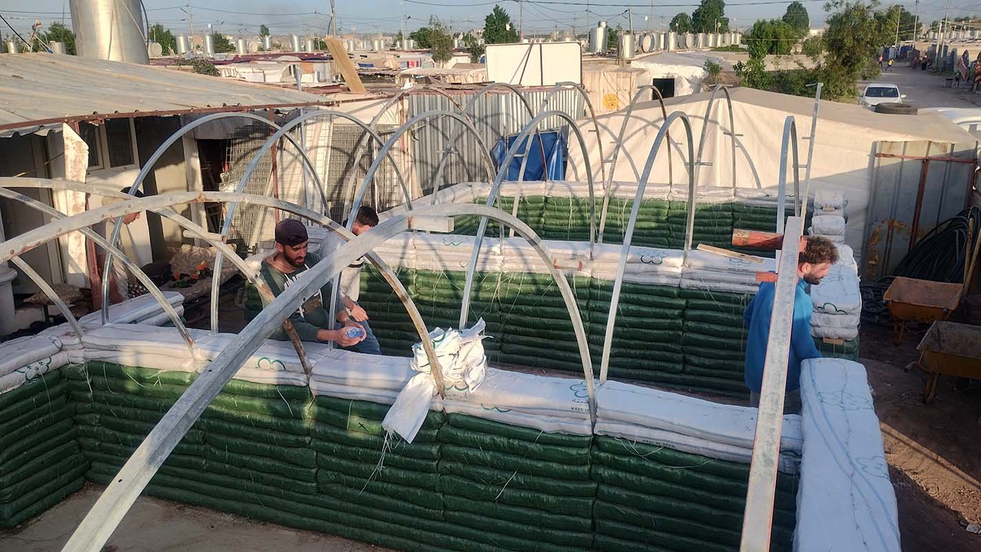 superadobe earth vault training in refugee camp