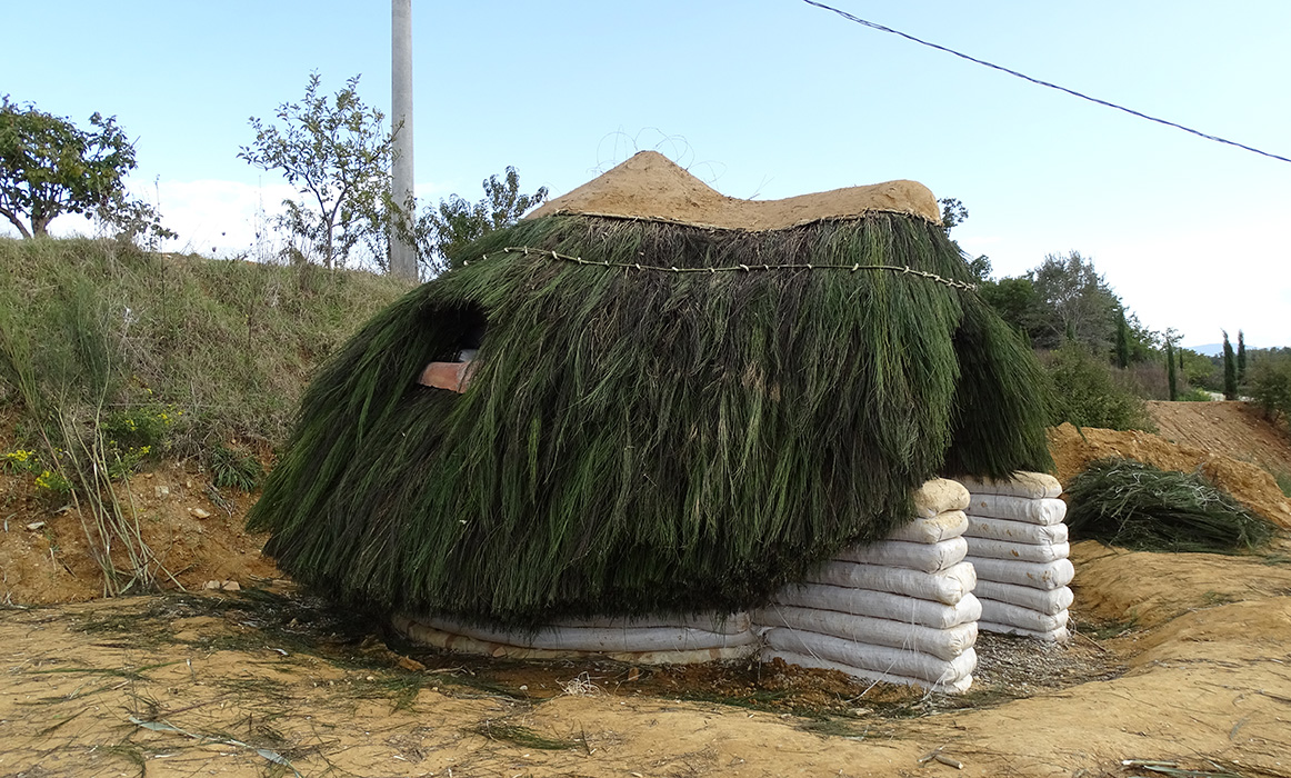 superadobe earthbag dome thatched with broom